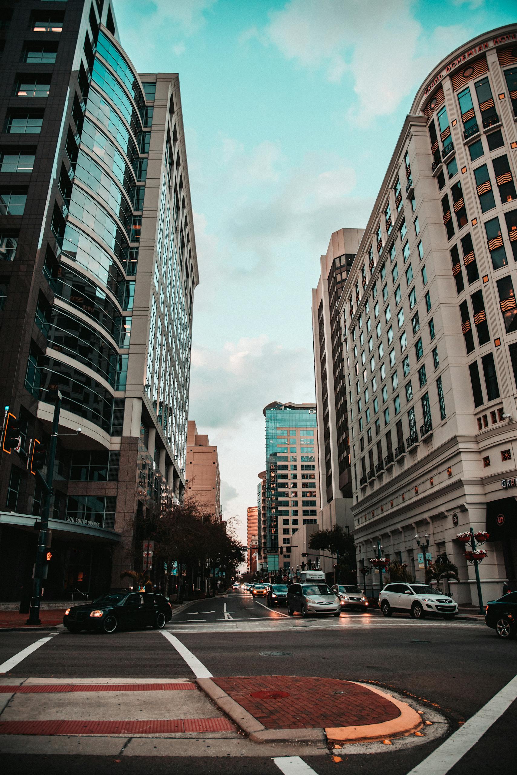 Vibrant city street with high-rise buildings and busy daytime traffic, representing local businesses competing for visibility on Google
